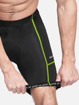 Men's cycling shorts in black with neon green trim, featuring side pockets and gripper leg hem. #color_Fluorescent Green