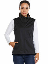 Woman wearing a black windproof softshell vest over a white long-sleeved shirt and blue jeans. #color_Black