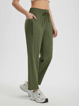 Lightweight women's running sweatpants in olive green, featuring drawstring and zipper pocket. #color_Army Green