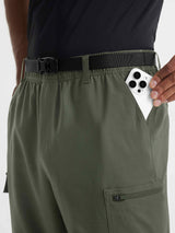 Baleaf olive ripstop hiking pants with hand placing smartphone in deep side pocket. #color_Army Green