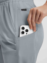 Woman places smartphone in pocket of grey UPF50+ water resistant hiking capris. #color_Light Gray