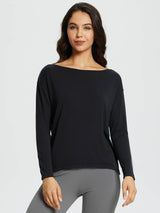 Black long-sleeve boat neck workout t-shirt for women, shown with grey leggings. #color_Black