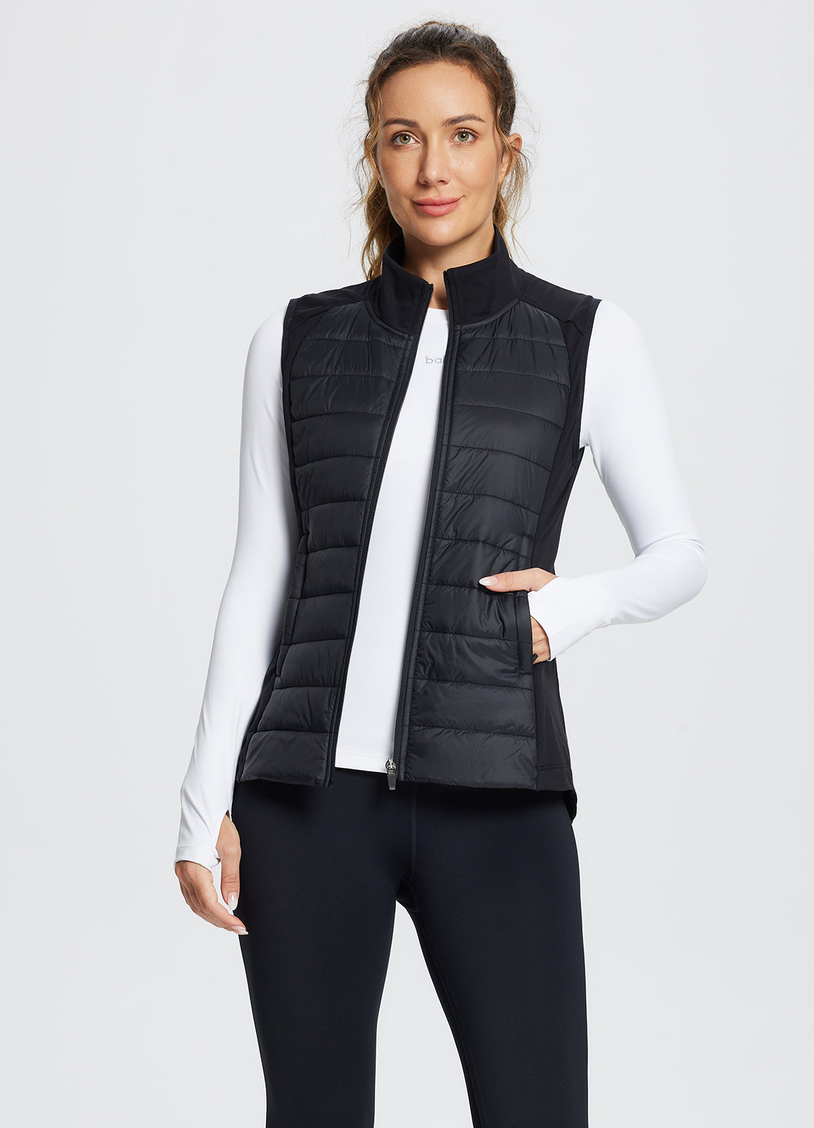 Black slim-fit running puffer vest with quilted front detail. #color_Black