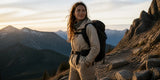 Woman hiker wearing hiking pants with a backpack on a mountain trail