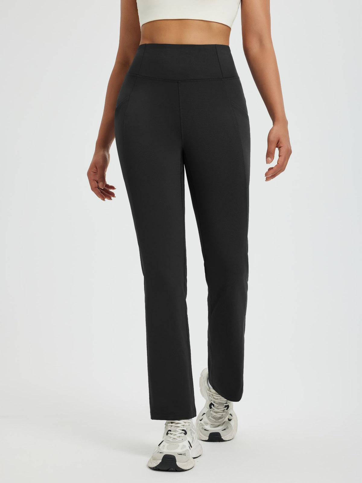 Women's black fleece running pants, boot-cut style, high-waist, straight leg, side pockets. #color_Black
