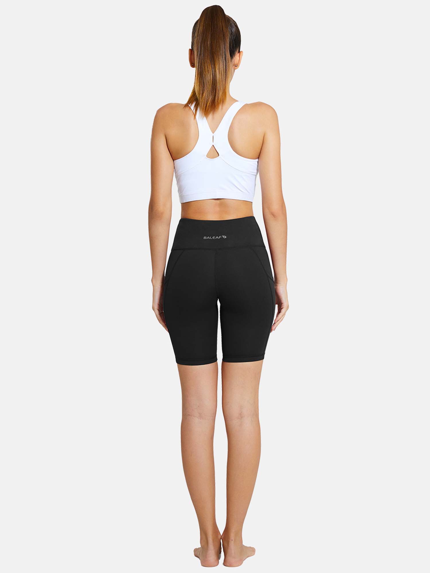 Baleaf black 7" yoga high waist comfort shorts with pockets, showcasing a woman from the back. #color_Black