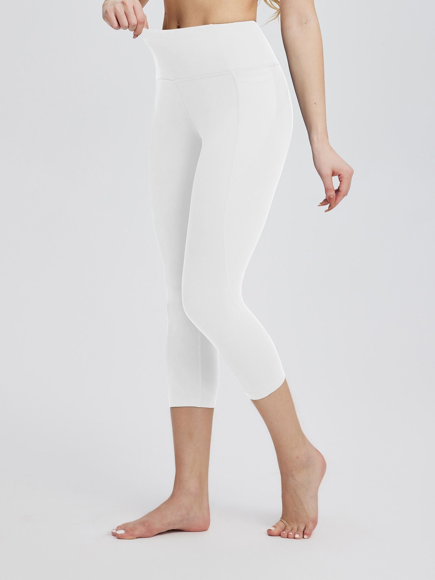 Women's white plus size high-waisted capris with pockets. #color_White