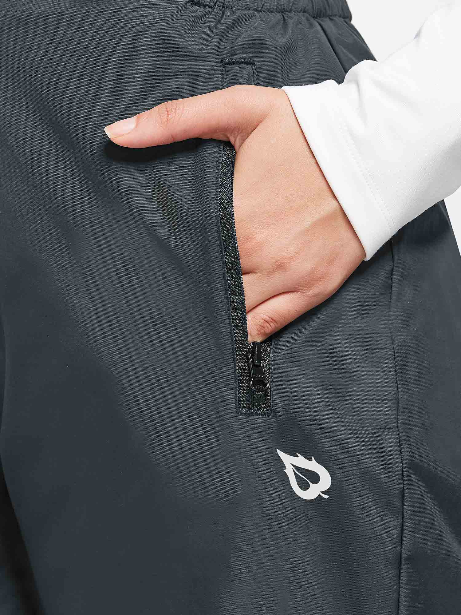 Dark grey outdoor ski bib pants with waterproof fabric, zippered pocket, and leaf logo. #color_Dark Gray