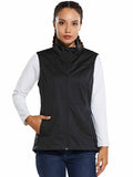 Woman wearing a black windproof softshell vest over a white long-sleeved shirt and blue jeans. #color_Black