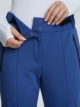 Blue soft-shell ski pants front view, showing adjustable waistband, snap closure, and zip pocket.