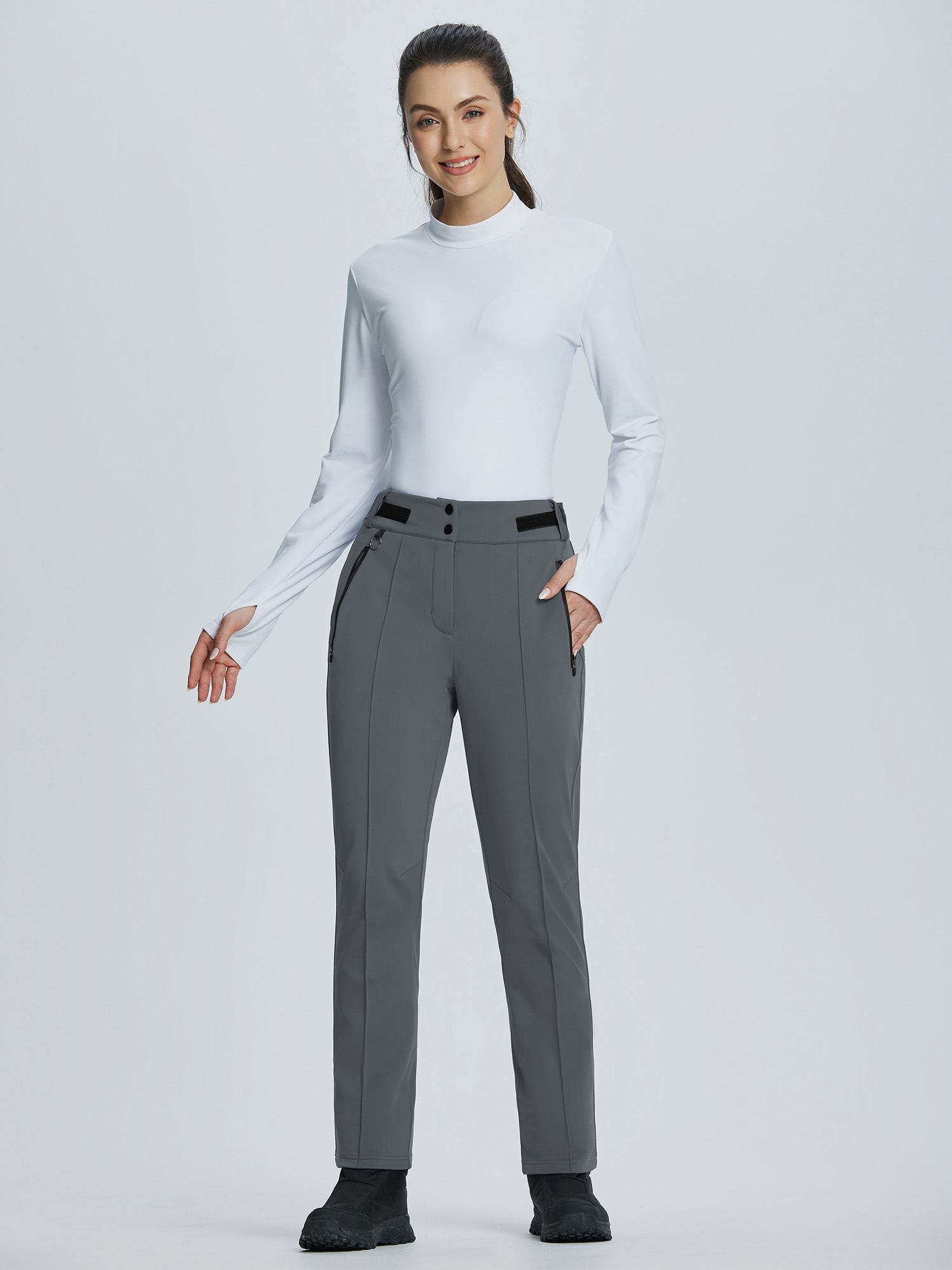 Model wearing grey soft-shell straight-leg ski pants with adjustable waistband and zip pockets. #color_Dark Gray