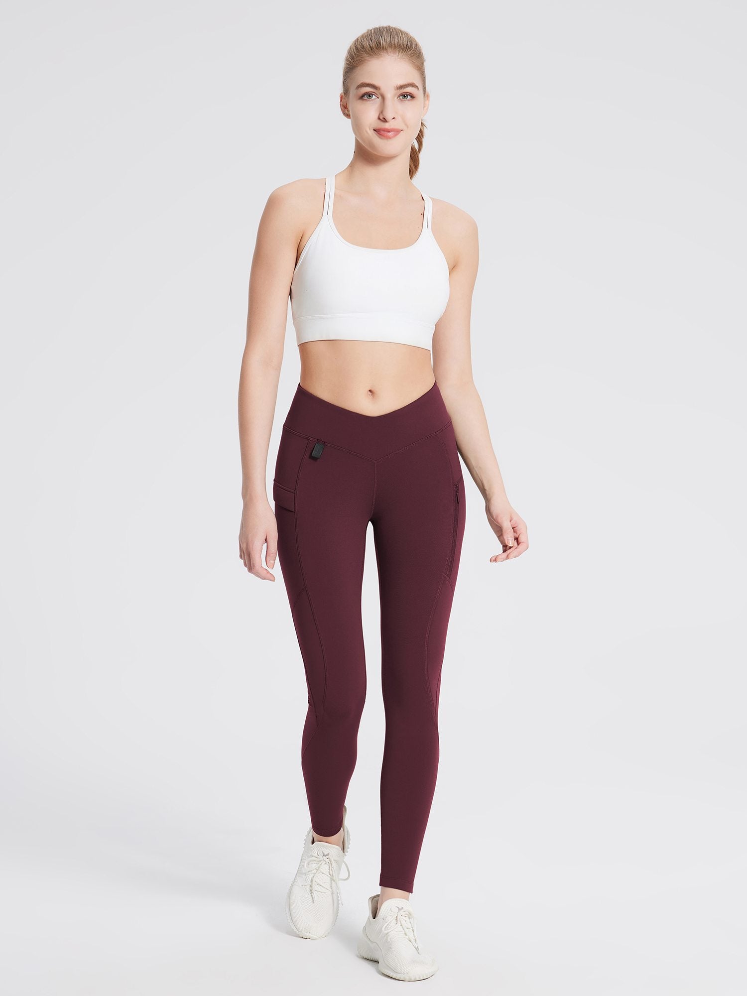 Fleece-lined burgundy hiking leggings with V-waist and zippered side pockets. #color_Wine Red