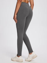 Woman wearing dark grey high-rise knit fleece pocket leggings and white sneakers #color_Lavender Gray