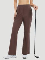Women's brown flare golf pants, 29" inseam, stretchy nylon spandex, holding golf club. #color_Dark Brown