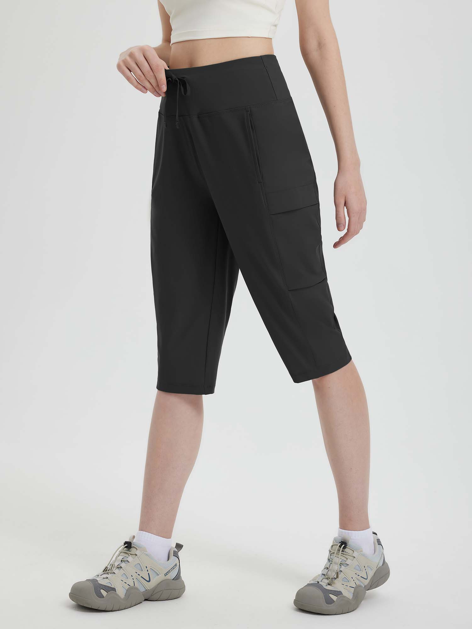 Black women's 15-inch hiking shorts with cargo pockets and adjustable drawstring waist #color_Black