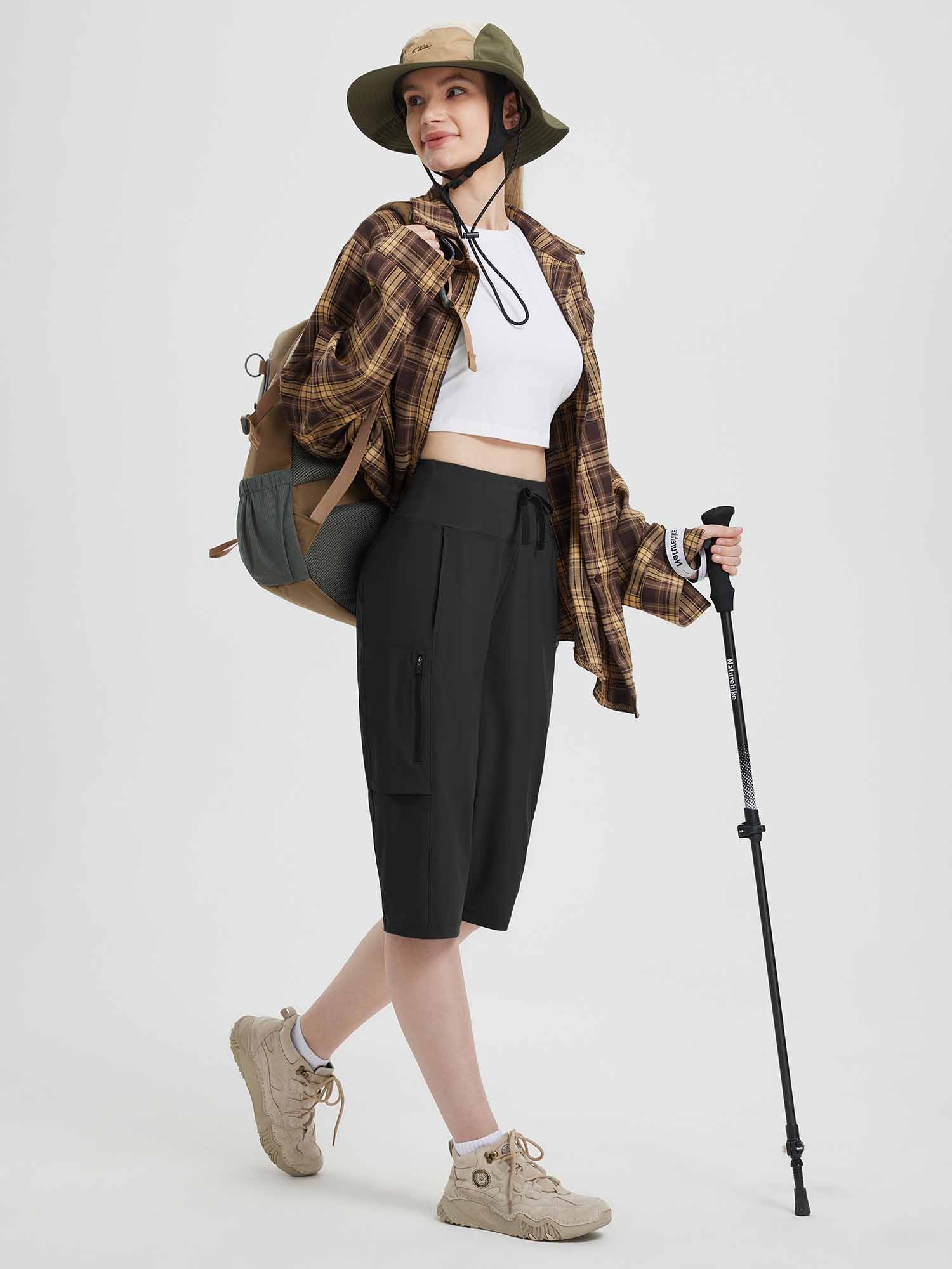 Black women's 15" hiking shorts with cargo pockets, elastic waistband, and trekking pole. #color_Black