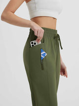 Women's running sweatpants in olive green, featuring functional pockets for phone and essentials. #color_Army Green