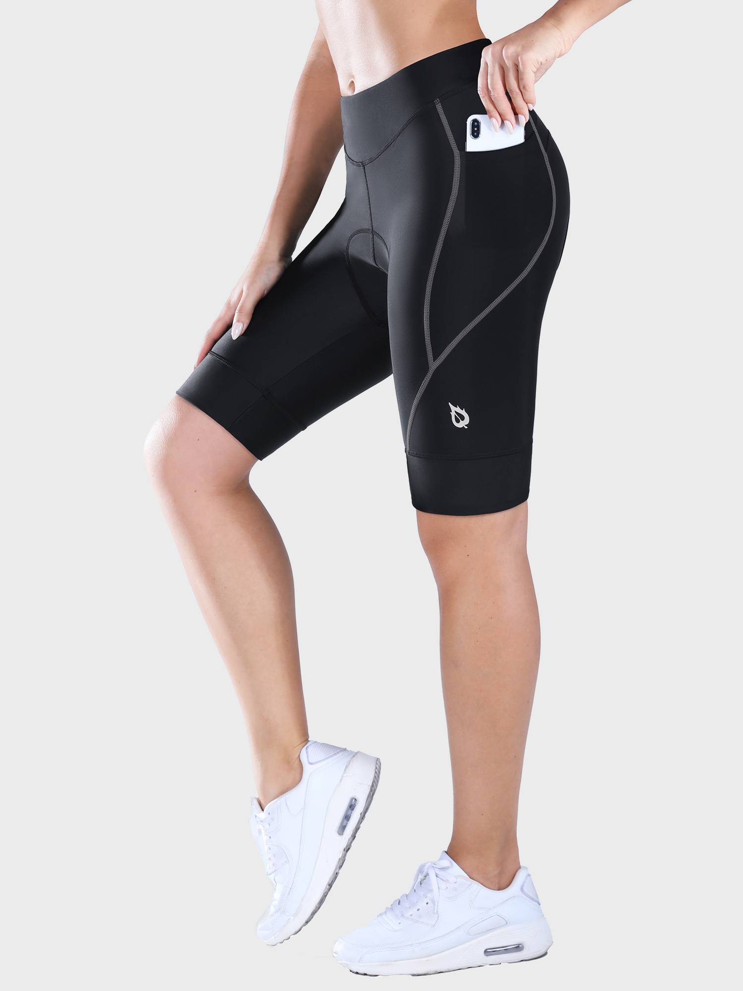 Woman wearing black 9-inch UPF 50+ padded cycling shorts with side phone pocket. #color_Dark Gray