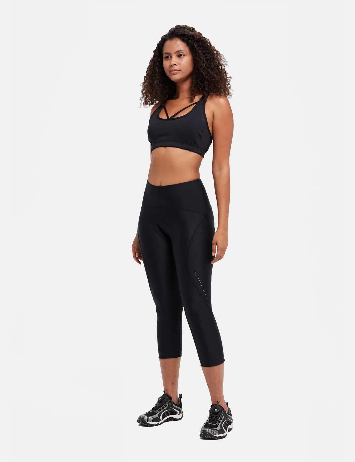 Women's black UPF 50+ high-waisted padded cycling capris with reflective side detail. #color_Black