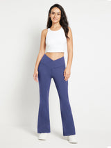 Blue crossover waist fleece-lined flare pants with high-rise design.