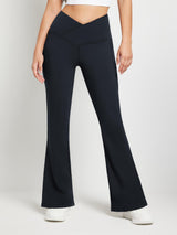 Crossover waist navy fleece yoga flare pants with V-seam and pockets. #color_Black