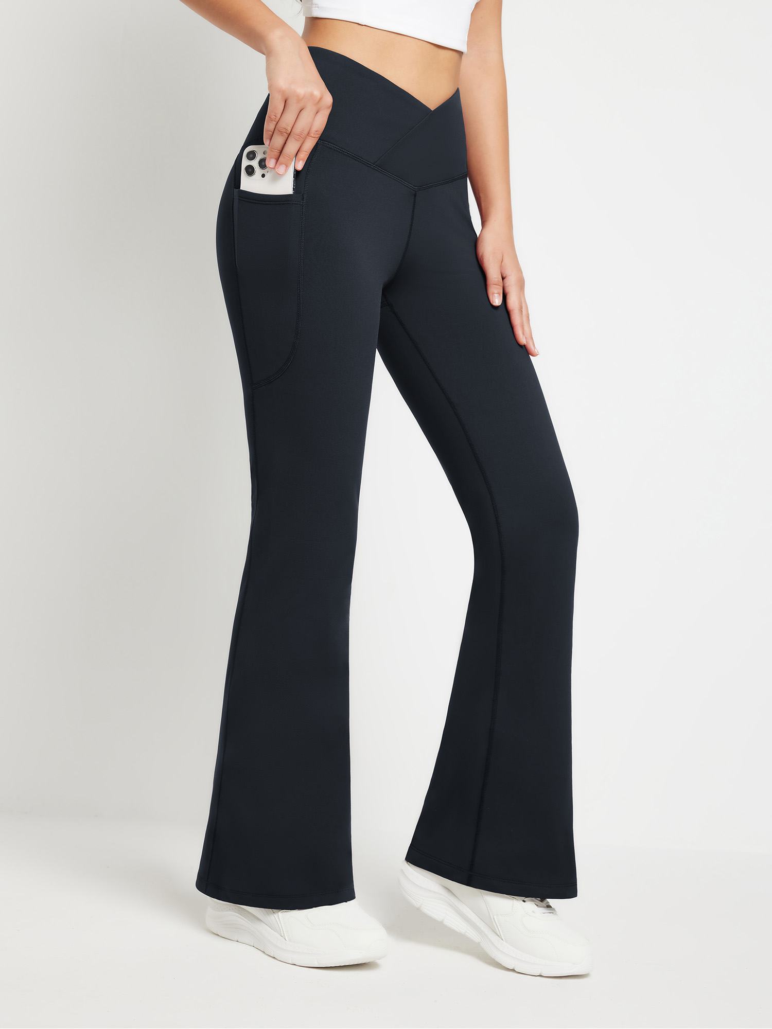Navy crossover waist fleece yoga flare pants with functional side pockets and V-seam detail. #color_Black