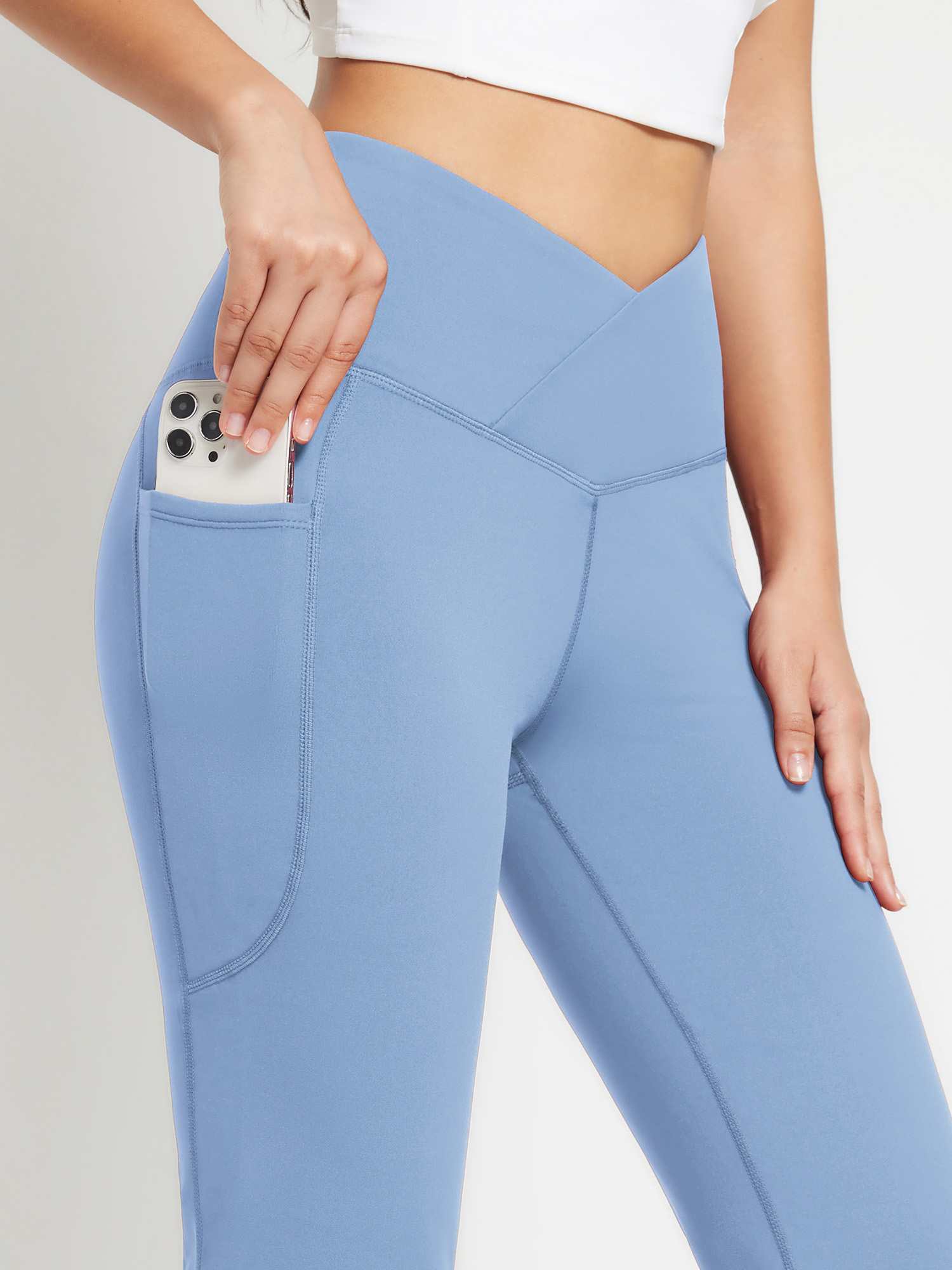 Blue crossover waist fleece yoga flare pants with phone pocket.