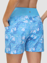 Women's blue 5-inch board shorts with white floral print, high waist, and pockets. #color_Print 2