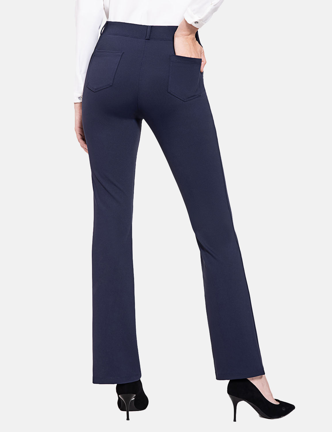 Navy blue workleisure bootcut pants with a mid-rise fit and two back pockets, worn with black heels.