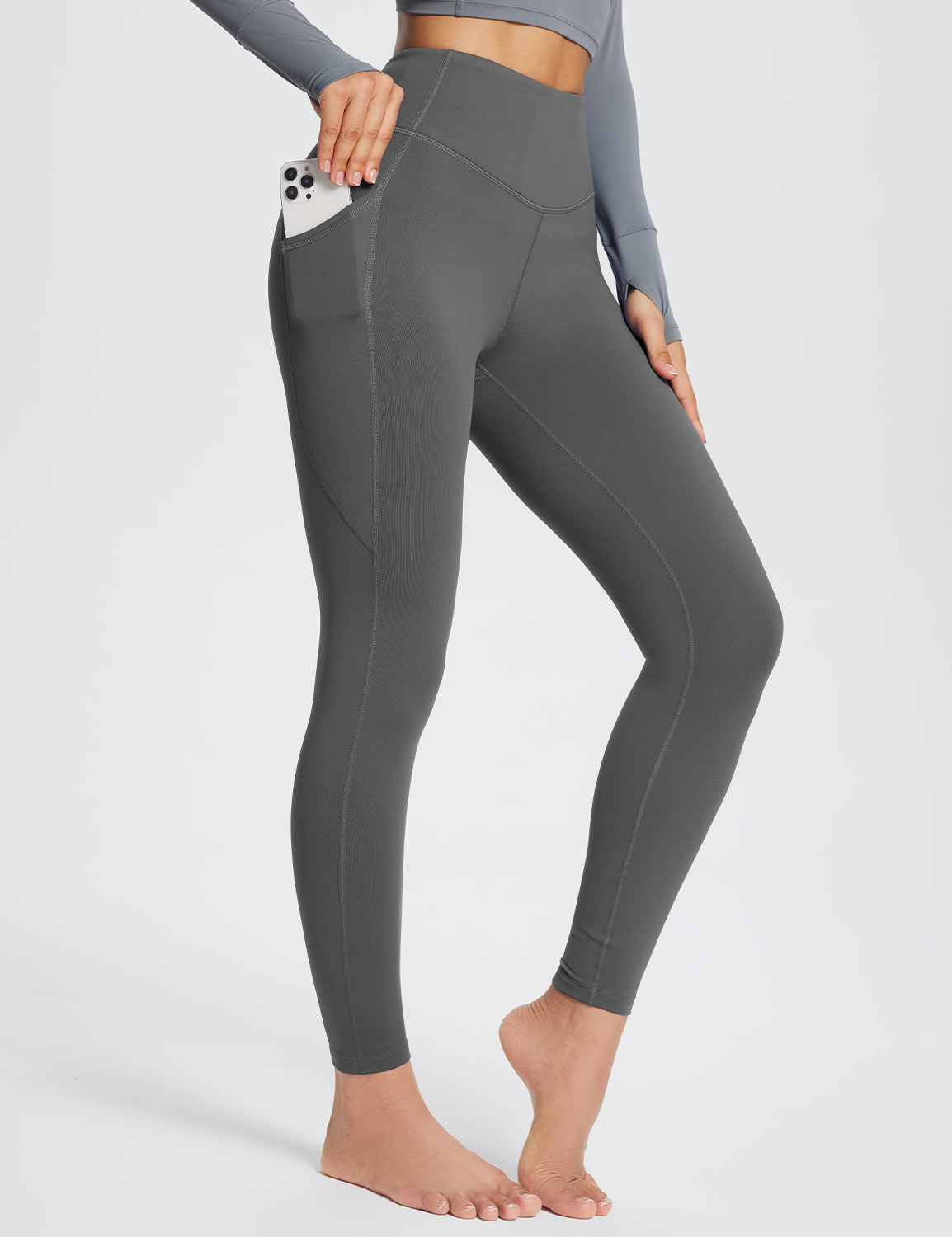 Grey high-rise thermal leggings with side pockets and contouring seams