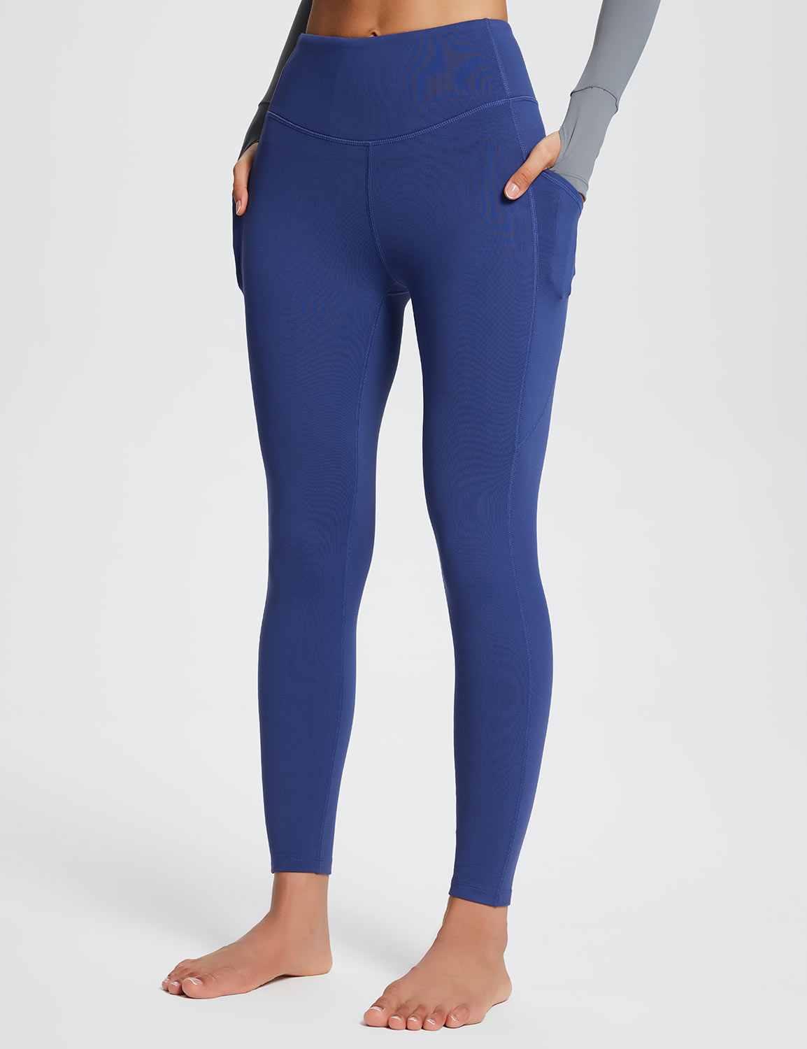 Laureate high-rise thermal leggings in blue with side pockets.