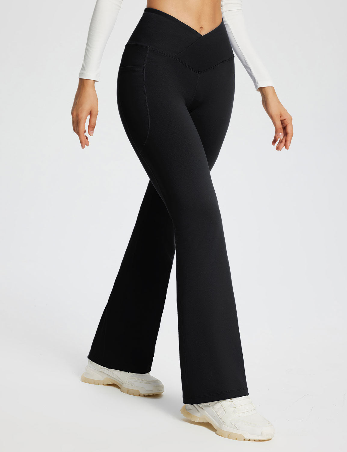 Laureate Women's black 29" crossover high-waisted flare yoga pants with pockets. #color_Black