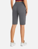 Woman from behind wearing gray Flyleaf 12" high-waisted running shorts and white sneakers.