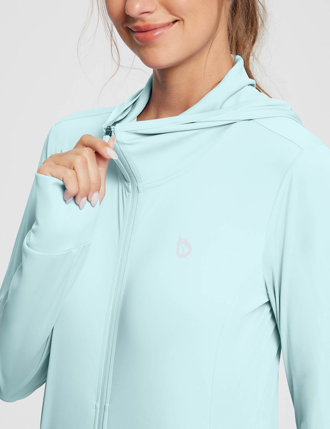 Woman zipping light blue UPF 50+ hooded jacket with logo. Baleaf Women's Lightweight Hoodie.