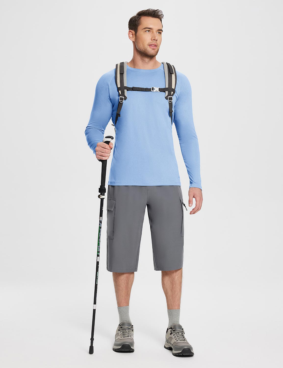 Men's light blue UPF 50+ long-sleeve sun shirt with gray cargo shorts and hiking gear